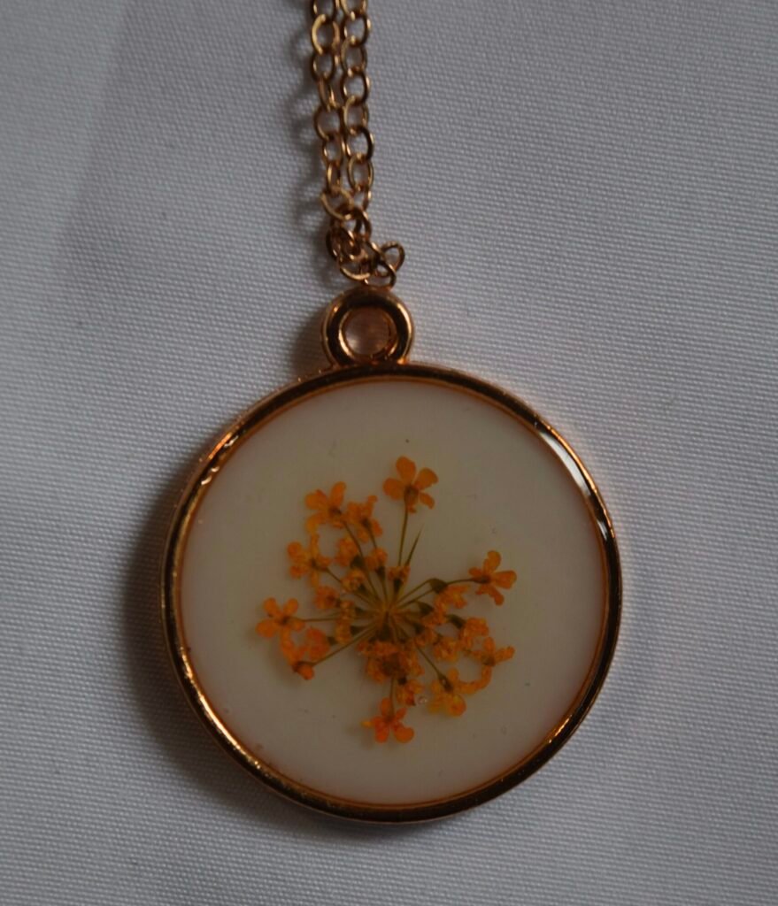 Orange flower on white background necklace
